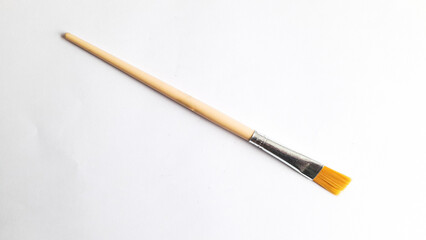 Top view of a variety of artist brushes on a white background with copy space for text. Creative postcard.