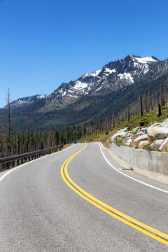 Scenic Road Surrounded By Trees And Mountains On A Sunny Day. Summer Season. Lake Tahoe, California, United States. Adventure Travel.