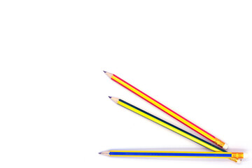 multi colored pencils placed on a white background