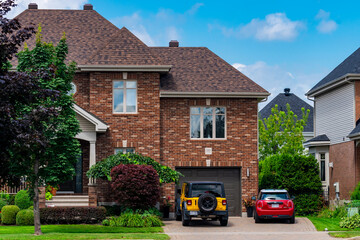 Full frame of a countryside house with two vehicles 