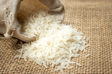 White rice in burlap sack bag. 