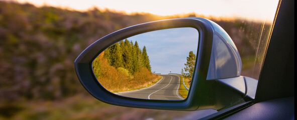 The view of the mountains in the car's rearview mirror. - Powered by Adobe