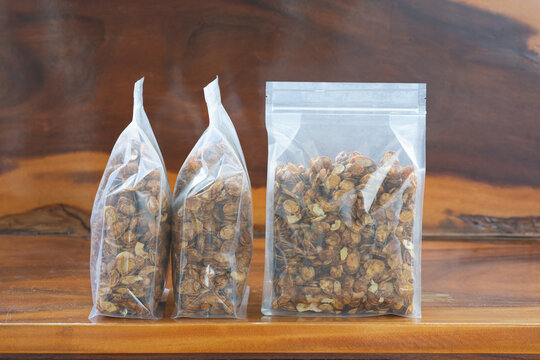 Caramel conflex in plastic bag package on wood table.plastic packaging concept.