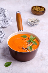 Red cream soup with sesame and basil