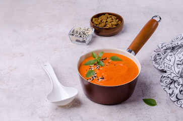 Red cream soup with sesame and basil