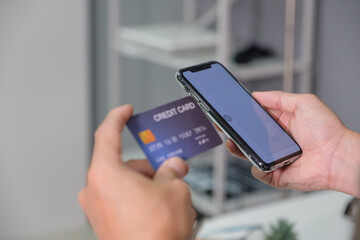 Man using smart phone and holding credit card with online shopping.Online payment concept. payment confirmation