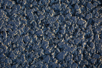 Black asphalt, texture. The resin is a garnet crumb.