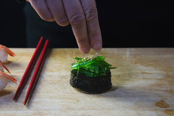 japanese maki sushi roll serving in oriental restaurant, chef is preparing japan tradition cookery menu, various different assorted luxury mixed healthy eating set concept