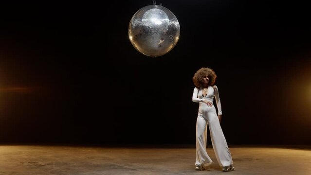 Charming African American Woman in Roller Skates Rides Around Under Disco Ball
