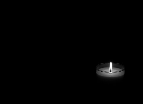 The concept of mourn, Candle dark on black background, RIP; grief or sorrow.