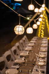 a Capiz shell ball lantern that sets the mood of a private dining dinner at the beach
