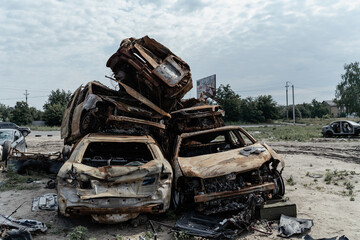 15.07.2022 Bucha Burnt and blown up car. Cars damaged after shelling. Traces of shots on the body of the car. War between Russia and Ukraine, Kyiv region - Bucha
