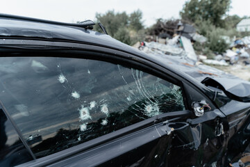 Shot car during the war in Ukraine. A car of civilians with shrapnel holes from explosions. Traces...