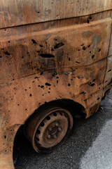 15.07.2022 On broken, burned cars, a close-up shot of areas and holes from shelling and shrapnel after the Russian invasion of Ukraine