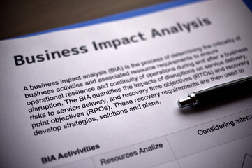 There is dummy documents that created for the photo shoot on the desk about Business Impact Analysis.