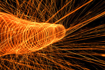 Ring made of sparklers on a black background.