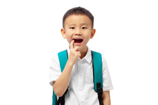 Kid with finger pointing at teeth, having toothache