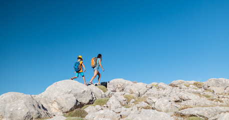 .A woman and a child are walking along a mountain path
