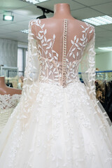 Fototapeta na wymiar Beautiful bride's dress close-up view from behind