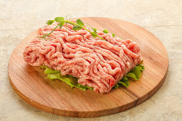 Raw minced pork meat over board