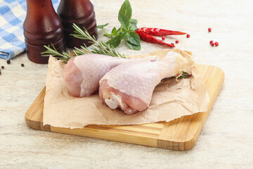 Raw chicken leg over board