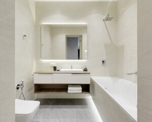 bathroom with beige tiles with stone texture, modern bathroom interior