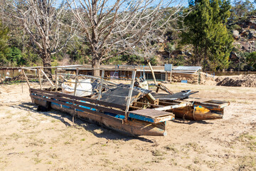 Fototapeta na wymiar Photograph of a flood damaged boat on a white sandy area of land