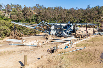 Photograph of a severely flood damaged building on the banks of the Hawkesbury river