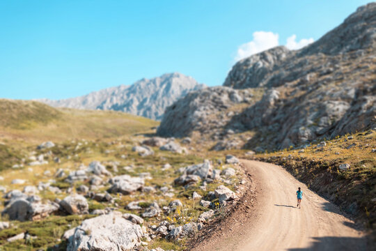 girl running on a mountain road