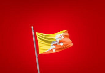 Bhutan flag waving in the wind on flagpole.