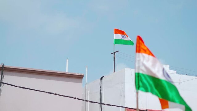 India flags waving on top of every houses of street at Bhuj, Kutch, India. Indian flag displaying on a pole in front of the house. Celebrating 75th anniversary of Indian Independence.