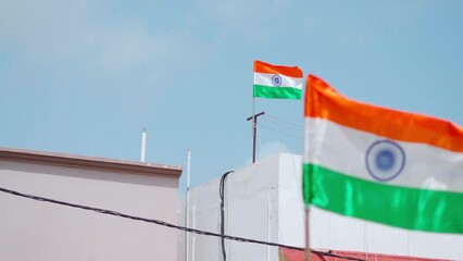 India flags waving on top of every houses of street at Bhuj, Kutch, India. Indian flag displaying on a pole in front of the house. Celebrating 75th anniversary of Indian Independence. Rack focus