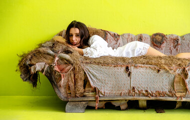 attractive, young, sexy, sensual, seductive woman on old tattered scrap junk couch recliner...