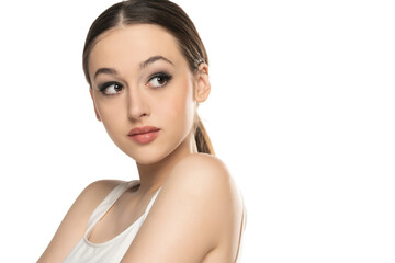 beautiful young serious women with makeup on a white studio background.