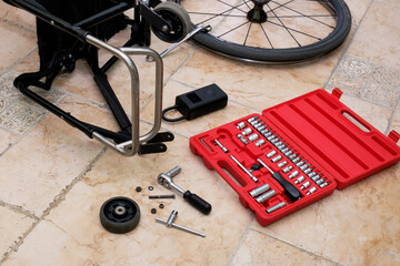 front wheel removed from wheelchair using a tool kit for minor repairs and cleaning