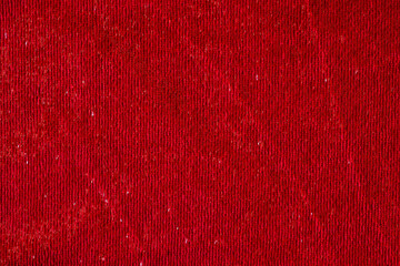 Dark red smooth textile material with shiny thread textured background