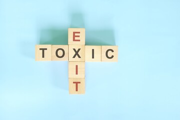 Resignation from toxic job, workplace or relationship concept. Exit and toxic wooden block...