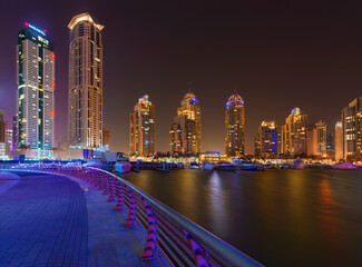 Dubai Marina walk at night with bay view on the right side