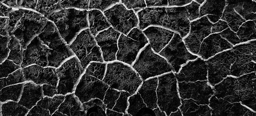 abstract black background with white cracks overlay ground cracked drought, old paint