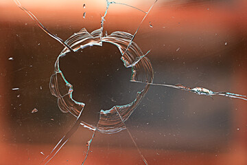 cracks on the glass impact on the glass, abstract background broken window damage