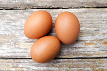 Farm fresh eggs isolated on wooden table.