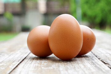 Farm fresh eggs isolated on wooden table.