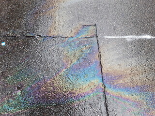iridescent light of gasoline oil on asphalt surface texture_2