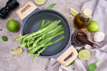 Green organic natural boiled Asparagus in a pot on kitchen table