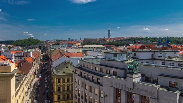 Top view from the height Powder Tower in Prague timelapse to Vitkov Memorial and Zizkov Television Tower with traffic on the street. Historical and cultural monument. Prague, Czech Republic.