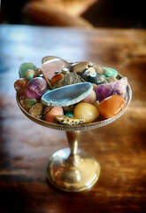 Silver cup full of semi-precious stones, soft focus
