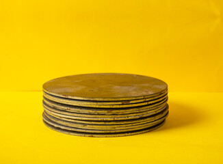 Pieces of steel pile up on yellow background for your product mockup space