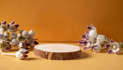 Wooden podium on yellow background with natural flowers with mockup product space