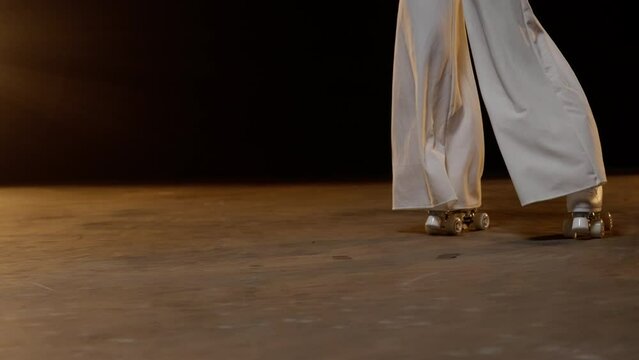 Female Legs in Vintage Roller Skates Skating Backwards Along the Stage