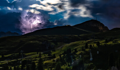 Lightning bolt hits during night thunderstorm in the Dolomites